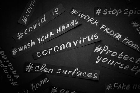 Coronavirus heading is written on black paper background with chalk.の写真素材