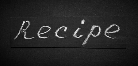 Black notebook on a black table. Notebook for recipes with blank for text.の写真素材