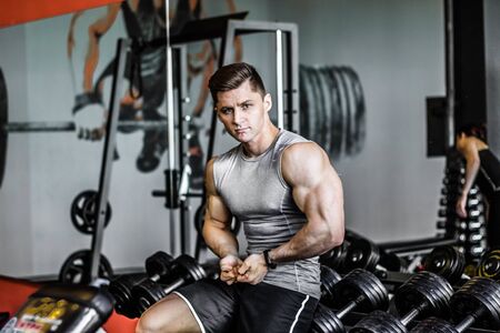 Muscular guy in the gym. Naked torso, European appearance. Concepts of fitness, health, bodybuilding, men in the category men's physique.の写真素材