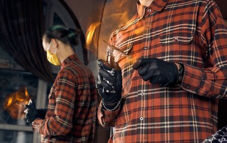 Male hairdresser in a protective mask and gloves, dressed in casual clothes. Client without a mask....