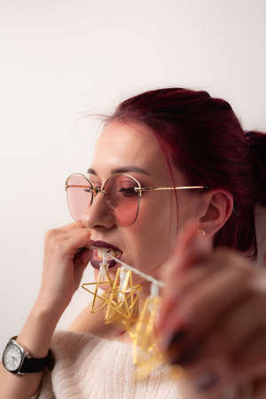 Portrait of a funny girl being played with a garland.の写真素材
