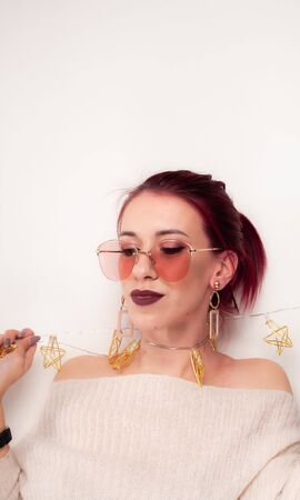 Portrait of a funny girl being played with a garland.の写真素材