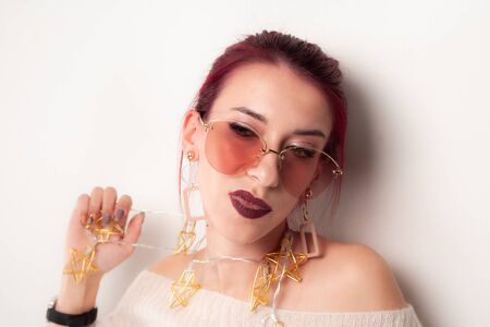 Portrait of a funny girl being played with a garland.の写真素材