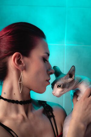 Portrait of a girl with a pet. Girl and hairless sphynx cat.の写真素材