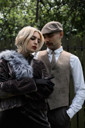 Portrait of a beautiful couple in vintage style. Retro style, classic clothes.