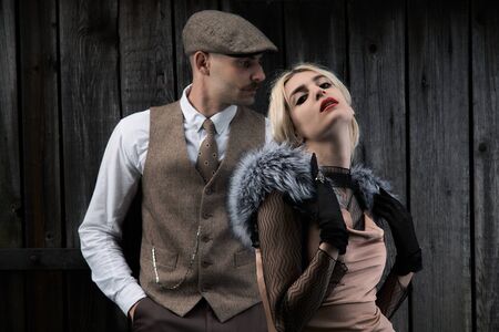 Portrait of a beautiful couple in vintage style. Retro style, classic clothes.
