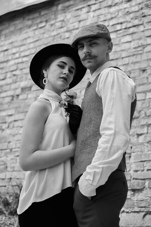 Portrait of a beautiful couple in vintage style. Retro style, classic clothes.