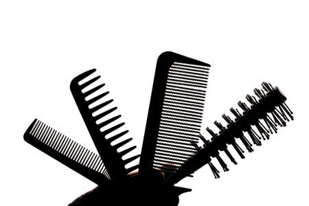 A set of combs is isolated on a white background in the form of a silhouette.