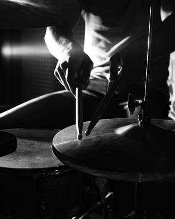 Drummer hits the cymbal with drumsticks, close-up photo. Focus on the cymbal.の写真素材