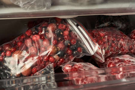 Freezing berries for the winter. Packaged frozen berries in plastic bags. In the freezer.