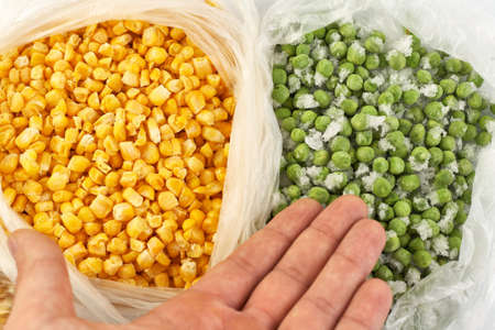 Frozen and packaged corn and green peas in a bag. Preparations for the winter.の写真素材
