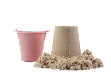 Bucket and sand isolated on white background. Decorative small pink bucket and kinetic sand, with clipping path for design use.の写真素材