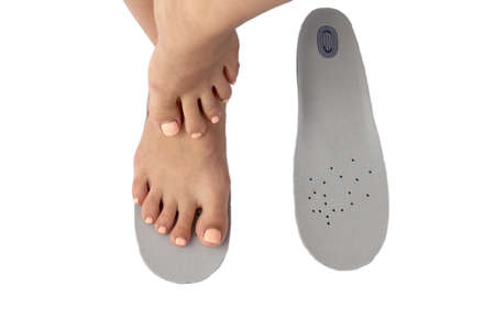 Female feet and insoles isolated on a white background.の写真素材