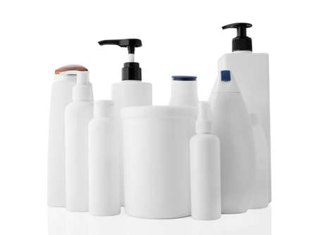 Set of white different plastic bottles and jars isolated on a clean white background, with reflection.の写真素材