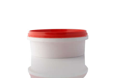 White plastic container isolated on a clean white background, with reflection.の写真素材