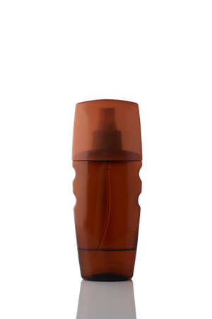 Bottle of spray sunburn oil isolated on white background. Transparent brown packaging.の写真素材