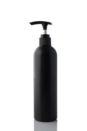Black plastic bottle with dispenser isolated on white background.の写真素材