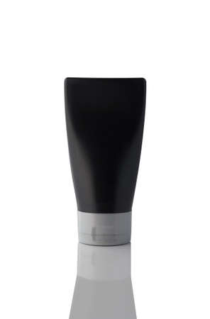 Inverted black plastic bottle isolated on white background.の写真素材