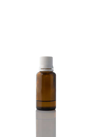 Glass vial of oil on a white background.の写真素材