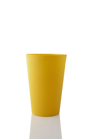 Plastic yellow cup isolated on white background.の写真素材