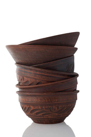 Stack of clay bowls isolated on white background.の写真素材