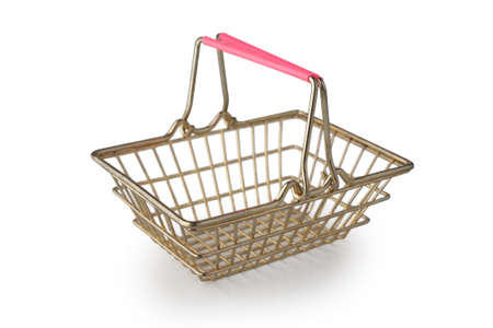 Empty metal grocery basket for shopping in supermarket isolated on white background side view. Symbol of consumer society.の写真素材