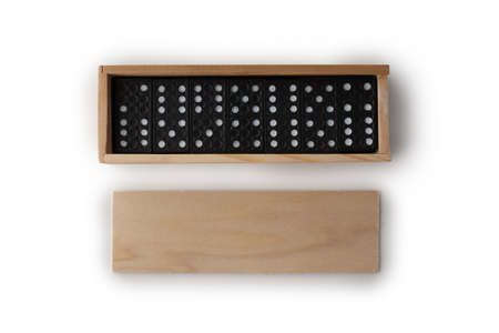 Black dominoes in wooden packaging isolated on white background.の写真素材