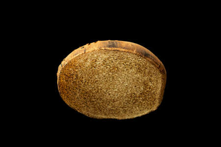 Toasted slice of burger bun isolated on black background.の写真素材