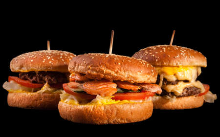 Set of different burgers isolated on black background. Hamburger, cheeseburger and fish burger.の写真素材