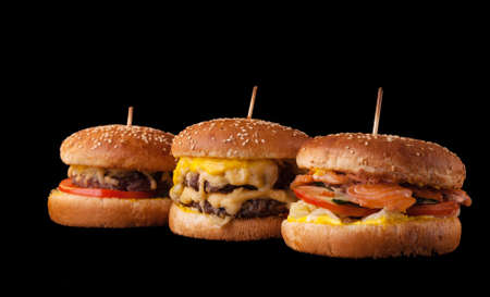 Set of different burgers isolated on black background. Hamburger, cheeseburger and fish burger.の写真素材