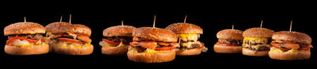 Burgers set isolated on black background. Hamburger, cheeseburger and fish burger for the restaurant menu.の写真素材
