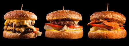Burgers set isolated on black background. Hamburger, cheeseburger and fish burger for the restaurant menu.の写真素材