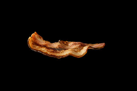 Fried bacon slice isolated on white background. Ingredient.の写真素材