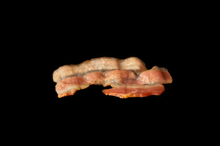 Fried bacon slice isolated on white background. Ingredient.の写真素材