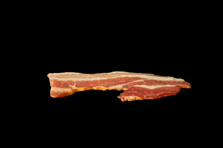 Smoked meaty slice of bacon isolated on white background. Ingredient.の写真素材