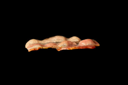 Fried bacon slice isolated on white background. Ingredient.の写真素材