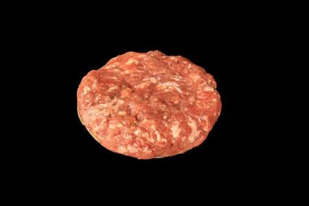 Raw uncooked meat cutlet isolated on black background burger ingredient.の写真素材