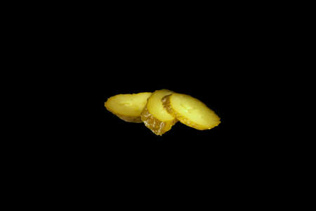 Canned cucumber slices slice isolated on black background, ingredient.の写真素材