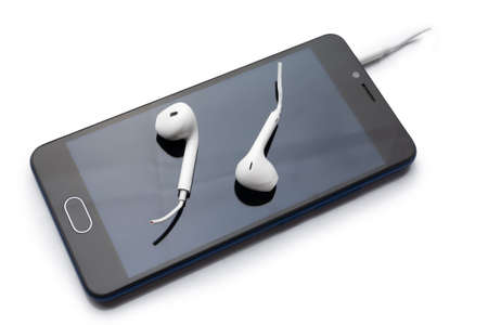Conceptual photo of cut off the earphones wire. headphones are a new trend. Wireless technologies are advancing. Wireless mobile headset.の写真素材