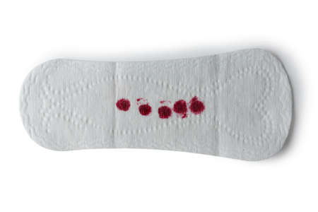 Bloody feminine pad on a white background.の写真素材