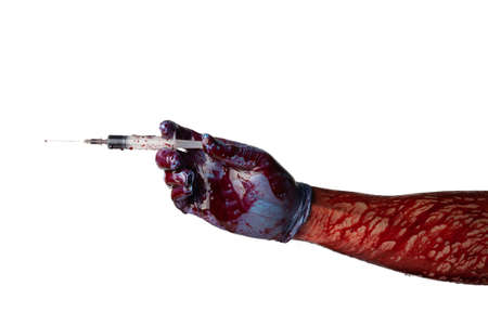 Bloody hand in medical gloves holds a syringe and makes an injection isolated on a white background.の写真素材