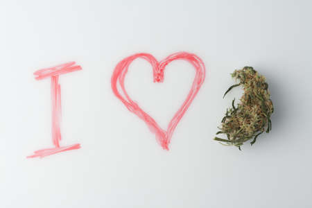 Love marijuana culture concept. Hemp bud and a drawn heart on a marker board.の写真素材
