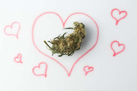 Love marijuana culture concept. Hemp bud and a drawn heart on a marker board.の写真素材