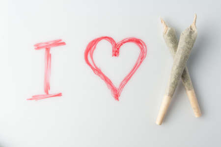 Love marijuana culture concept. Joint hemp and a drawn heart on a marker board.の写真素材