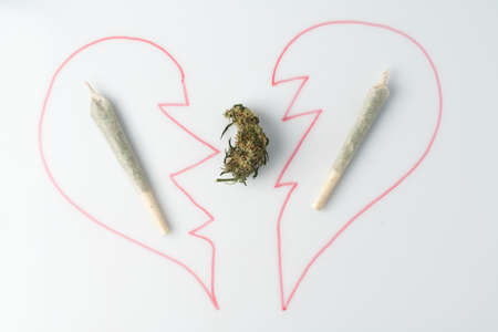 Love marijuana culture concept. Joint hemp and a drawn heart on a marker board.の写真素材