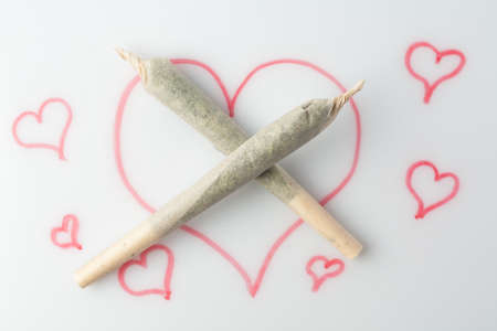 Love marijuana culture concept. Joint hemp and a drawn heart on a marker board.の写真素材