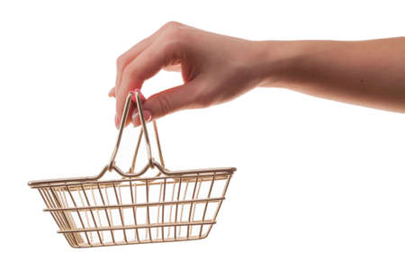 Female hand holds a shopping basket isolated on white background.の写真素材
