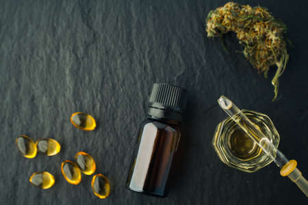 Cannabis bud and oil cbd on a dark, flat lay photo product hemp.の写真素材