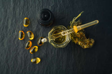 Cannabis bud and oil cbd on a dark, flat lay photo product hemp.の写真素材