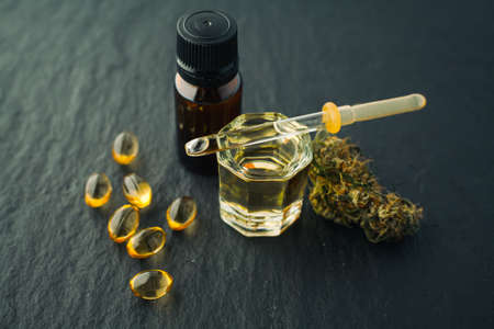Cannabis bud and oil cbd on a dark, flat lay photo product hemp.の写真素材